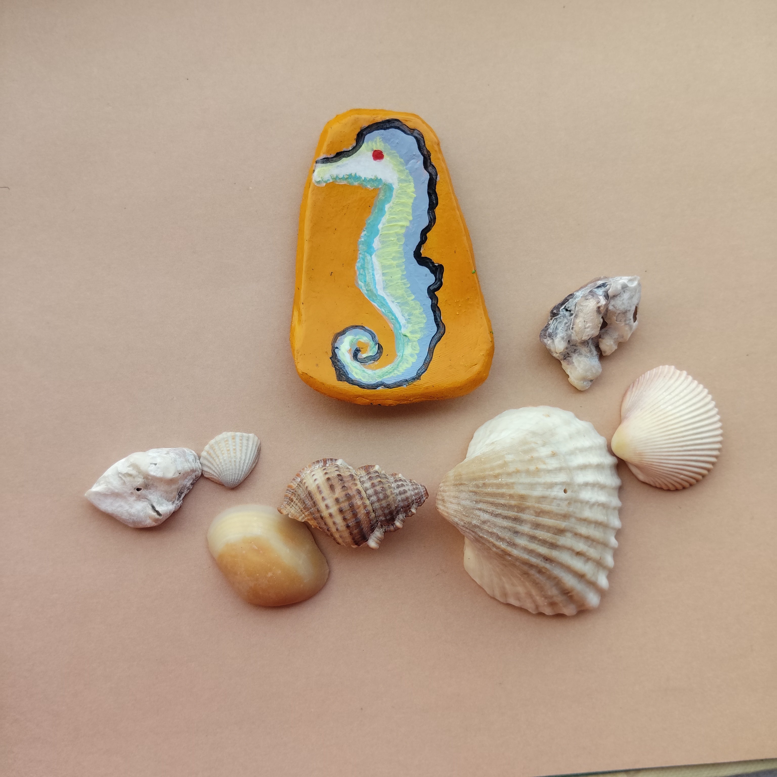 Artistic magnet with a seahorse design surrounded by various shells on a beige background - Sustainable Home Decor & Upcycled Glass