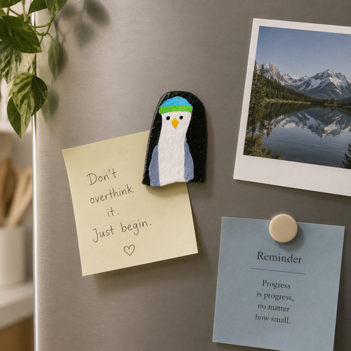 Artistic bird shaped magnet hold small notes on the refrigerator with other naturistic photo and reminder note.