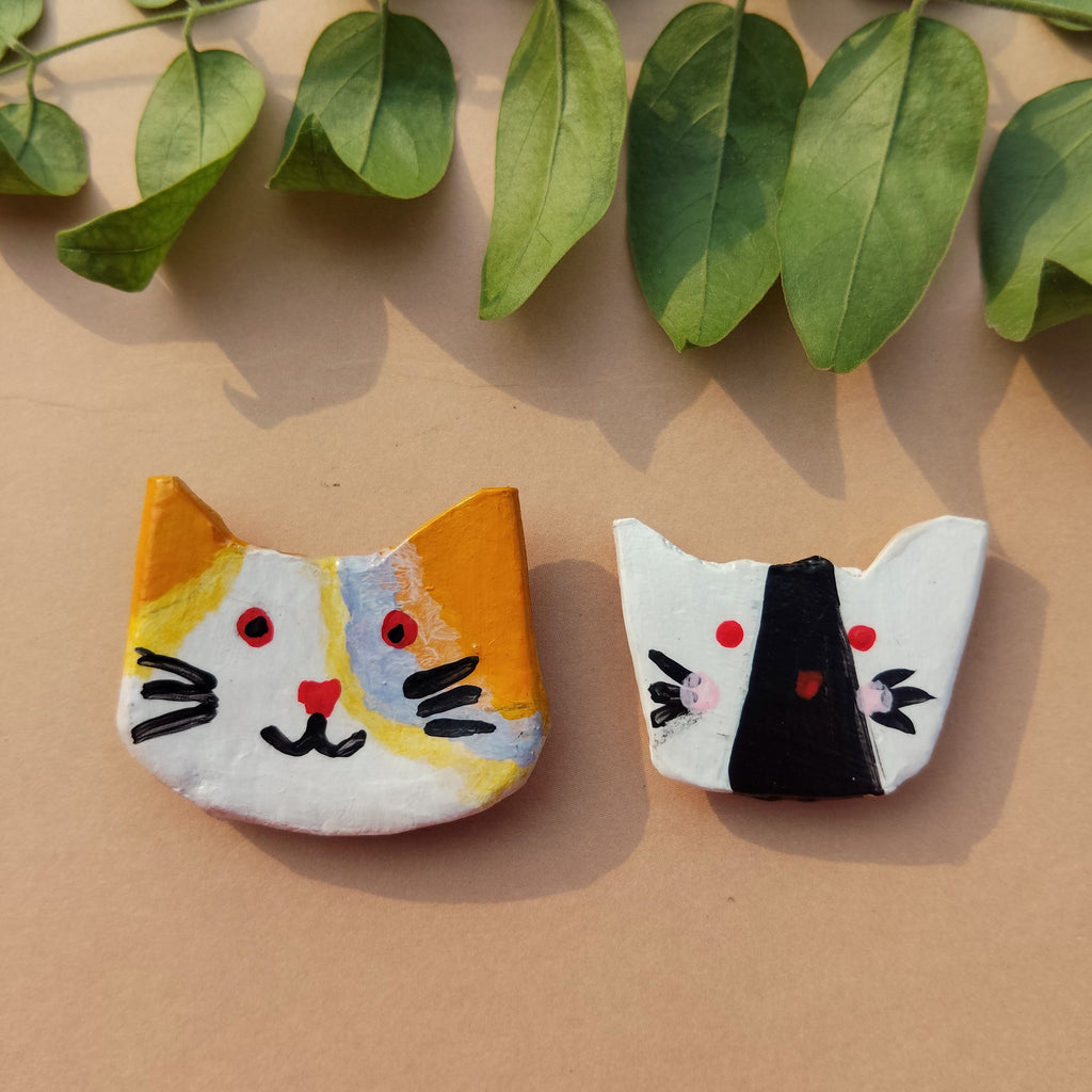 Two cat figures on a beige background with green leaves. - Sustainable Home Decor