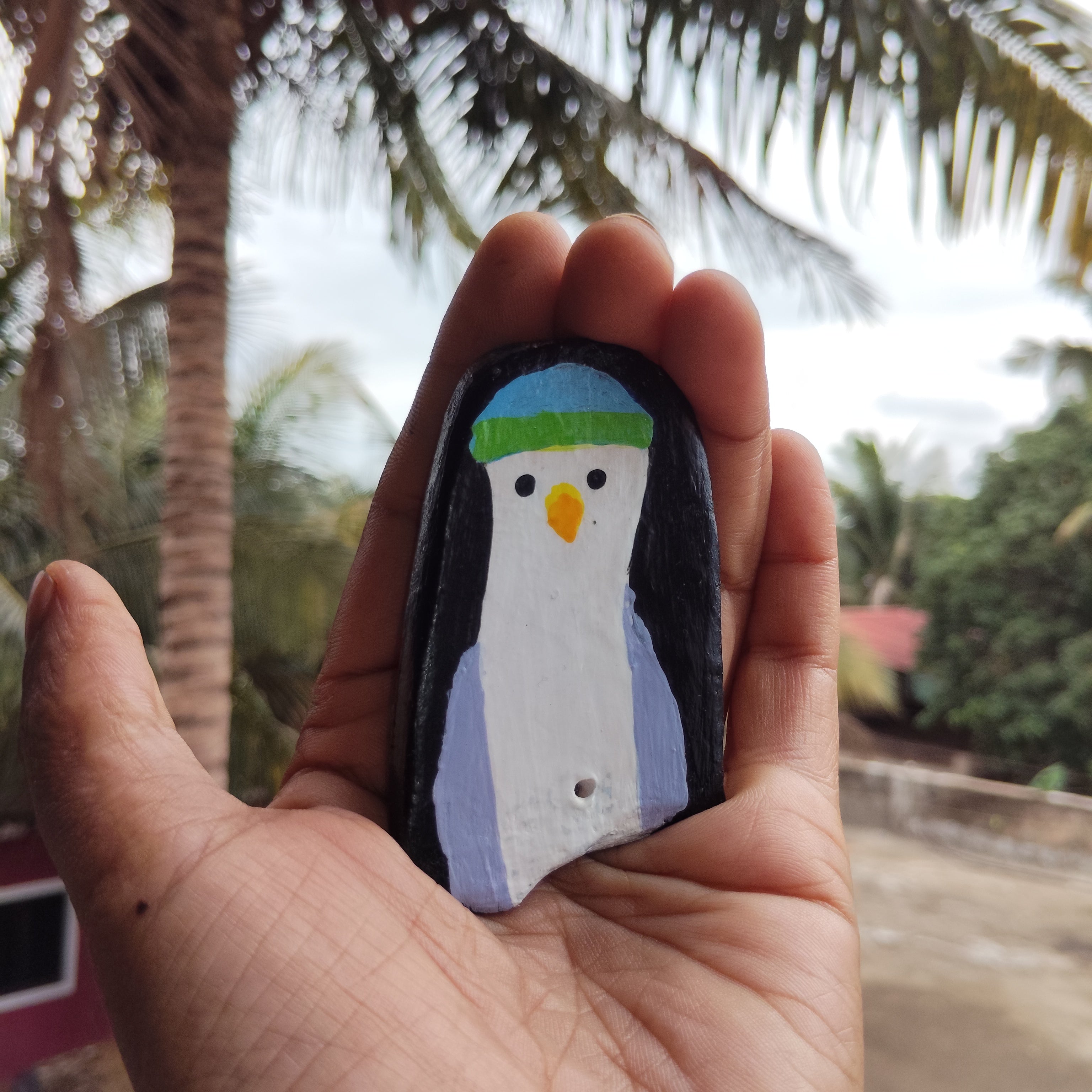 A hand holding artistic bird themed magnet in blurred naturistic background. - Sustainable Home Decor & Upcycled Glass