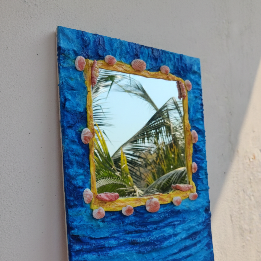 Close-up of a textured art with a mirror in between showing reflection of palm tree background.