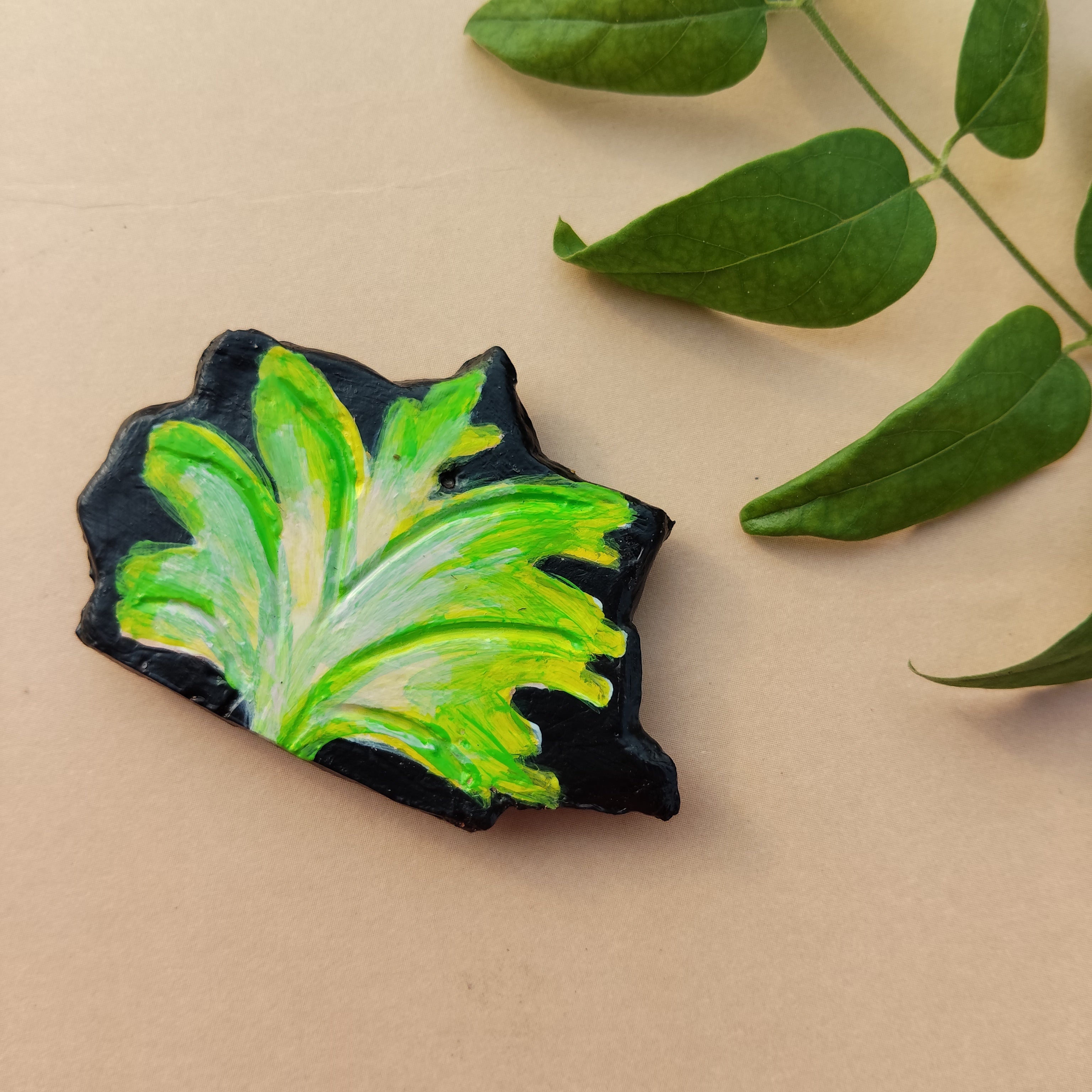 Artistic eco-friendly magnet with green leaf design on a beige background with real green leaf on one corner. - Sustainable Home Decor & Upcycled Glass