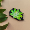 Green leaf-shaped object on a beige background