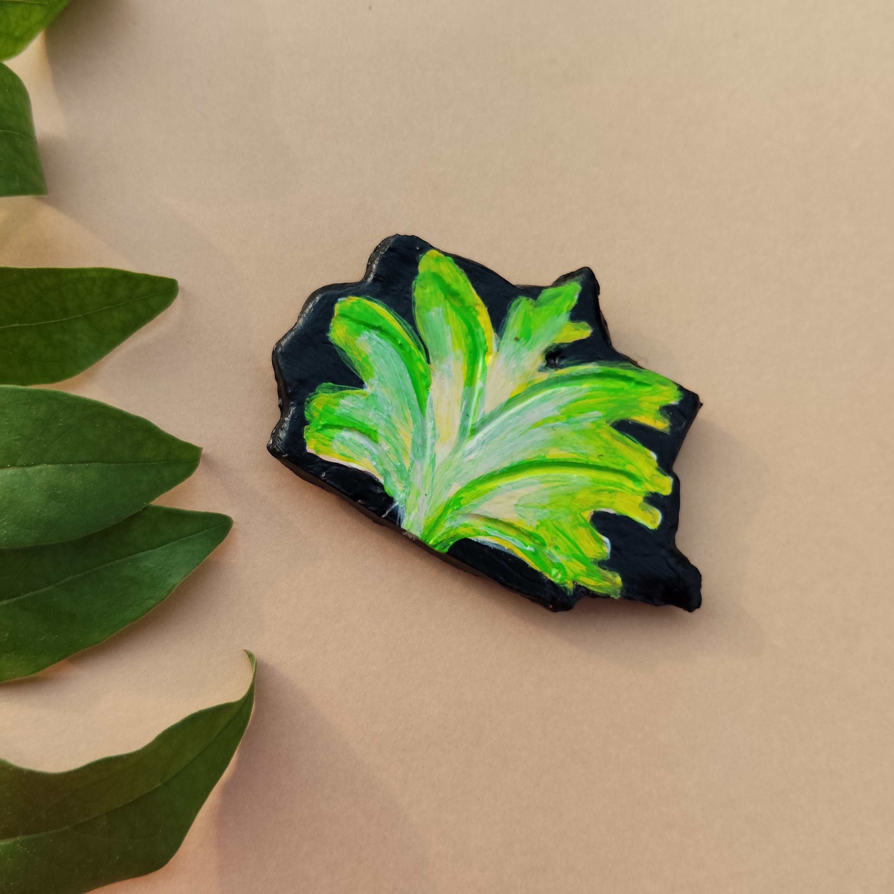 Green leaf-shaped object on a beige background - Sustainable Home Decor & Upcycled Glass