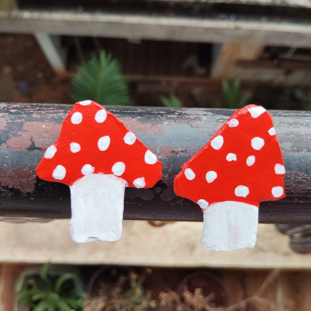 Red and white polka dot mushroom magnets combo on a iron bar with a blurred natural background. - Sustainable Home Decor