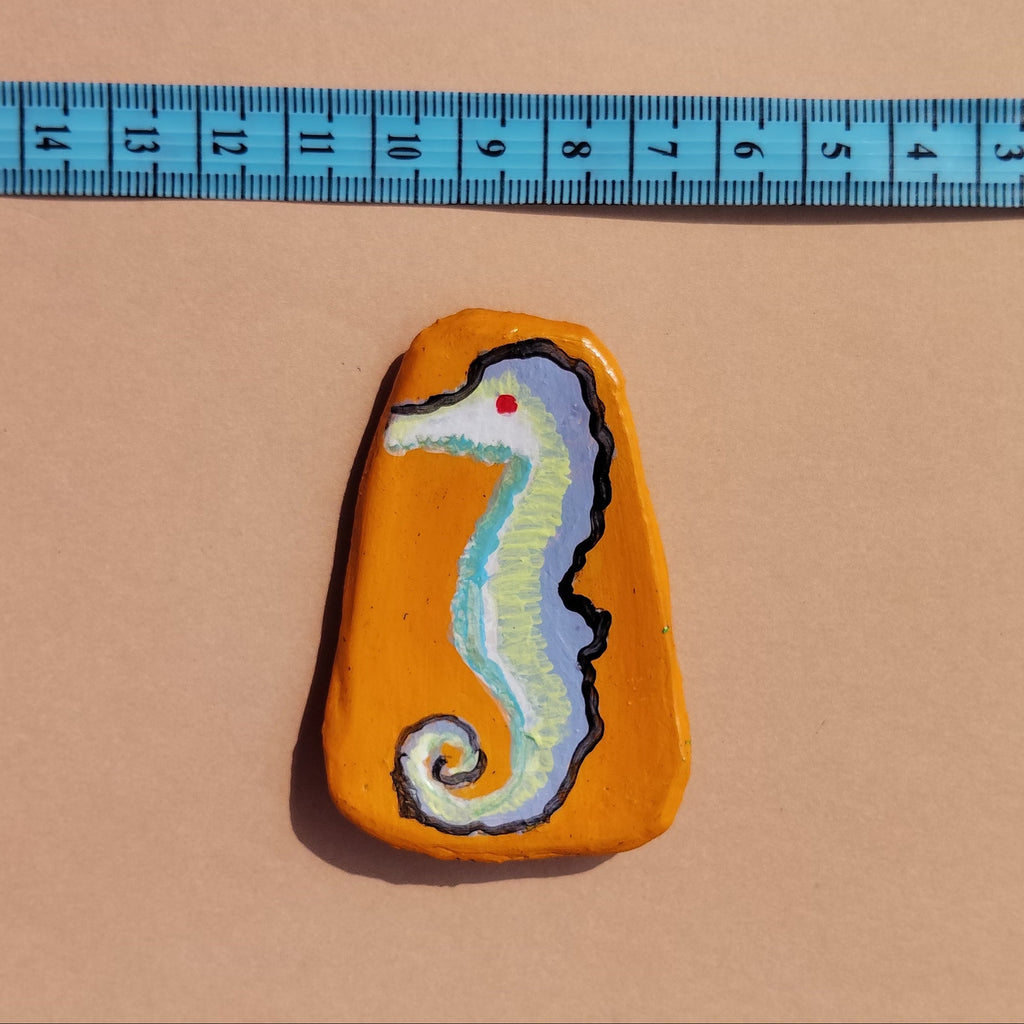 A hand-crafted magnet lying on beige background with measuring tape. - Sustainable Home Decor