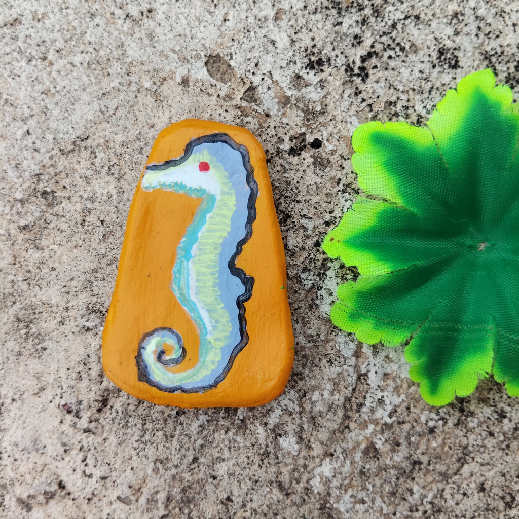 Painted seahorse on a hand-crafted sustainable material with a green leaf - Sustainable Home Decor