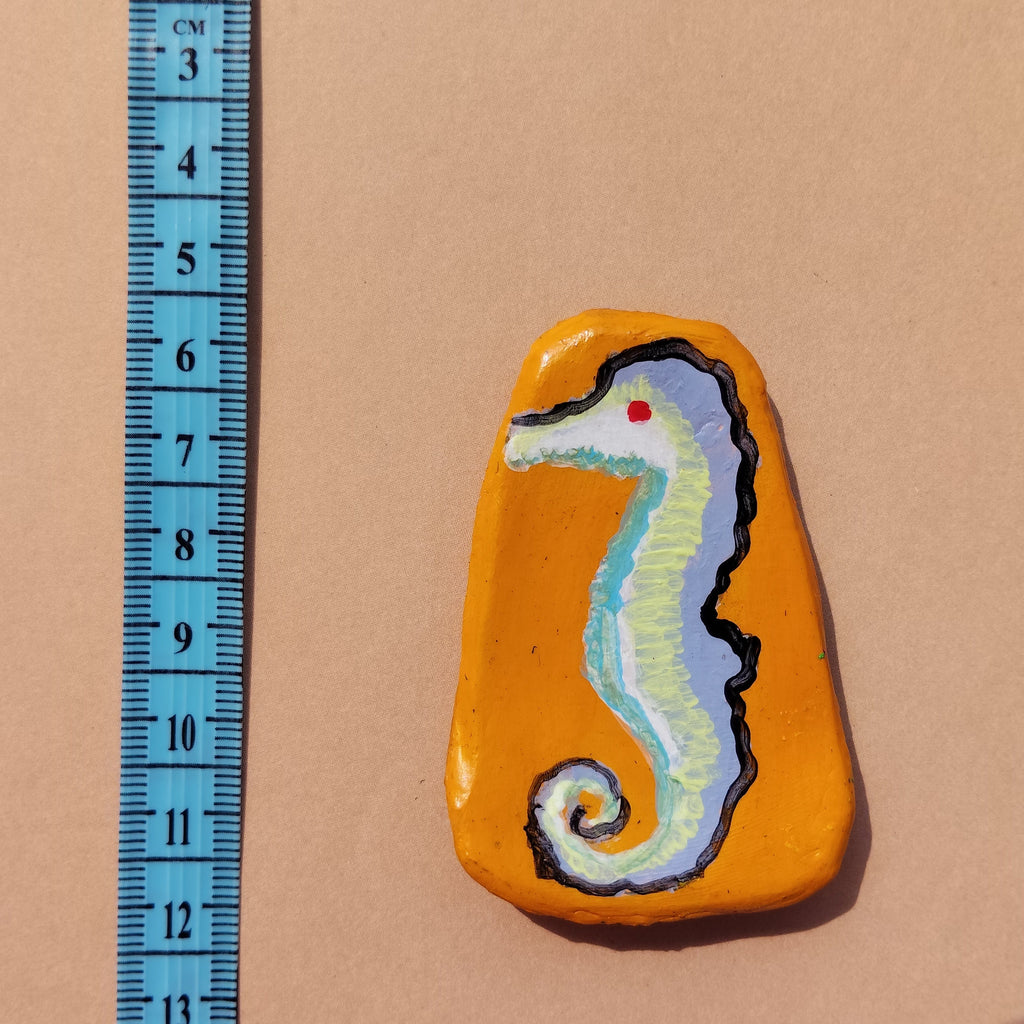 Artistic mini magnet with a painted design of a seahorse on a beige background, accompanied by a ruler for scale. - Sustainable Home Decor