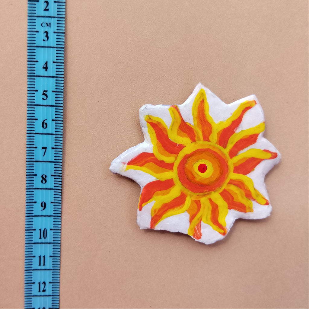 Artistic sun-shaped magnet with a ruler for scale on a beige background - Sustainable Home Decor