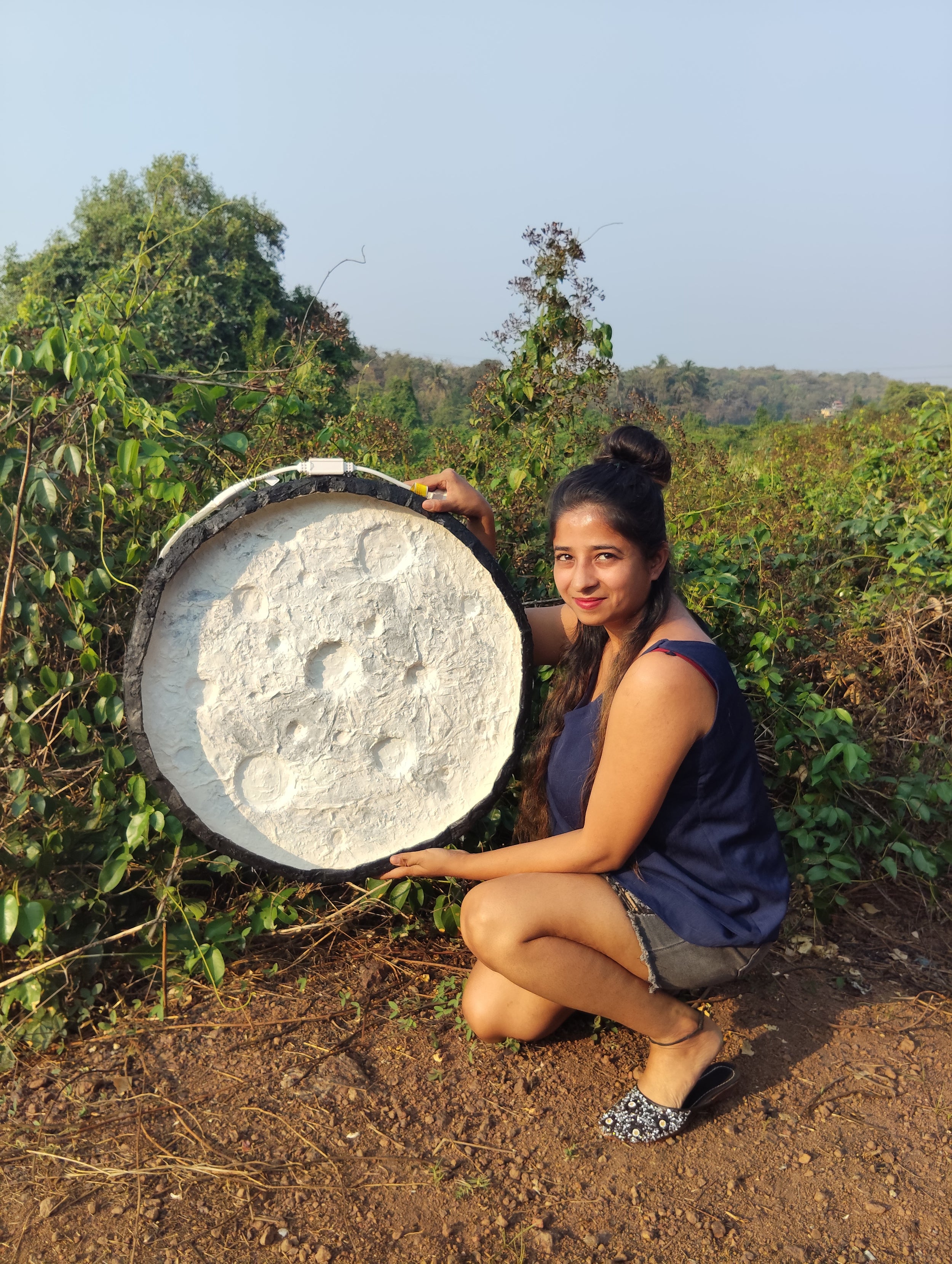 The video shows how a textured art is created in layers using piles of paper waste giving it resemblance of an actual moon surface and converted into a functional artistic wall decor.
